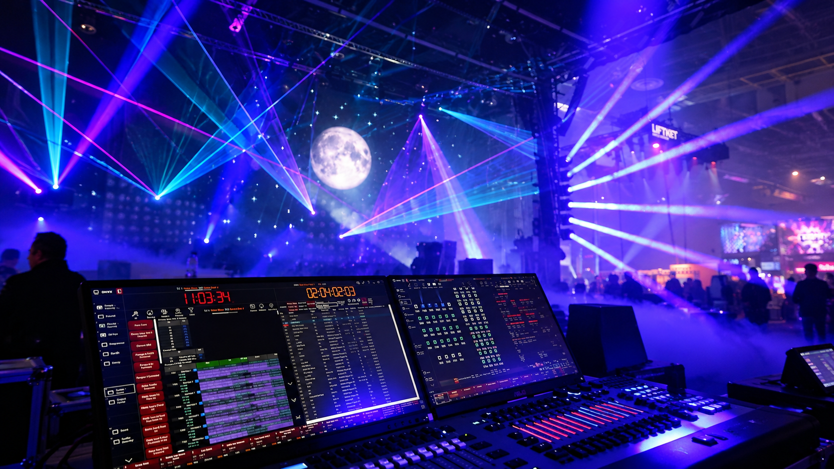 A lighting console in front of a stage filled with blue and purple laser beams